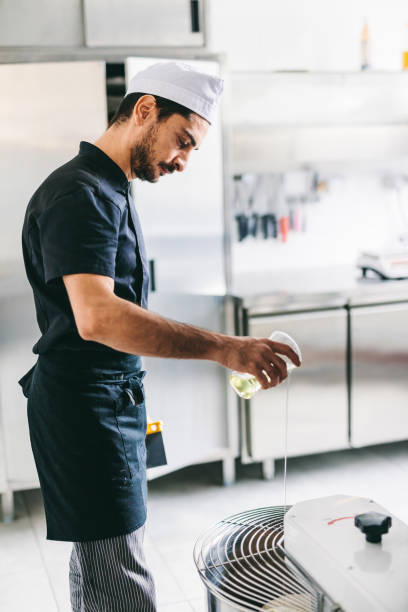 istock Italian chef pizzaiolo preparing pizza dough in restaurant kitchen 1434363376