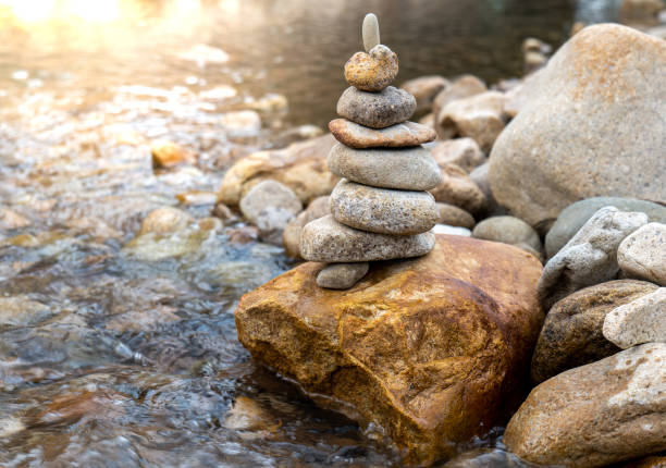 istock Zen concept, Stone balance in river, stone pyramid. 1434368093