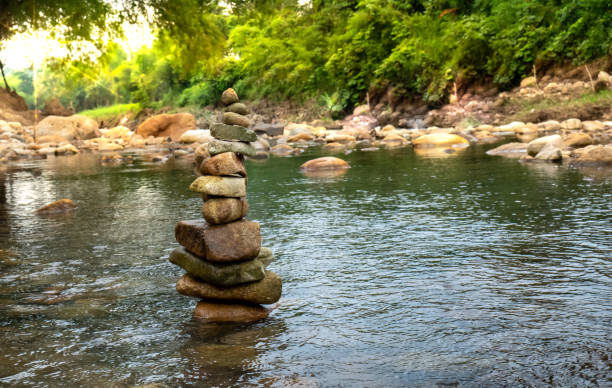 istock Zen concept, Stone balance in river, stone pyramid. 1434368095