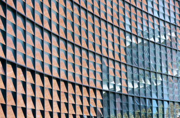 istock abstract pattern of steel decoration with glass wall window panel reflection brick wall and sky modern architecture facade exterior. 1434368947