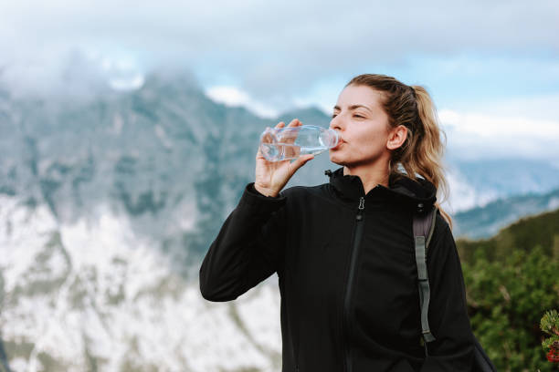istock Female hiker drinking water on a hike in the mountains 1434370426