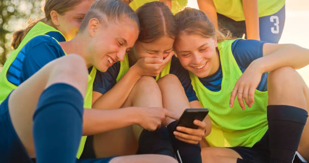 istock Football players using smartphone 1434372346