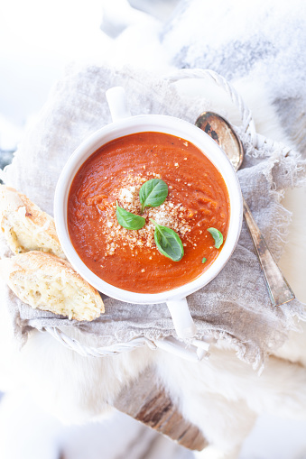 Creamy tomato soup with parmesan and basil