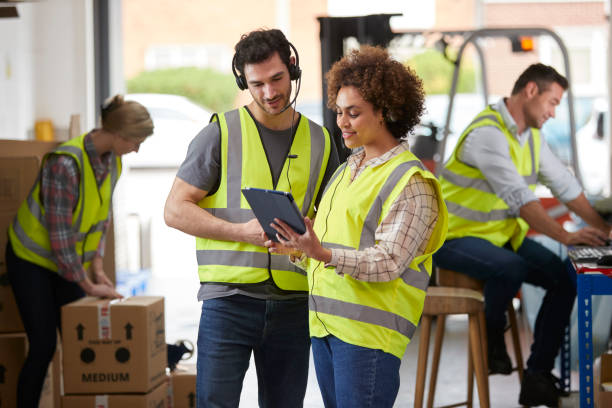 istock Male And Female Workers Wearing Headsets In Logistics Distribution Warehouse Using Digital Tablet 1434373107