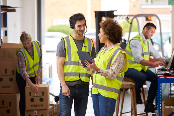 istock Male And Female Workers Wearing Headsets In Logistics Distribution Warehouse Using Digital Tablet 1434373975