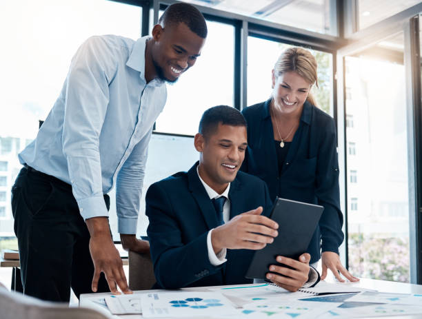 istock Innovation, teamwork and meeting with team on tablet working on strategy, planning and paper statistics. Happy business people, consulting on tech, data or charts in office, company or workplace. 1434376121