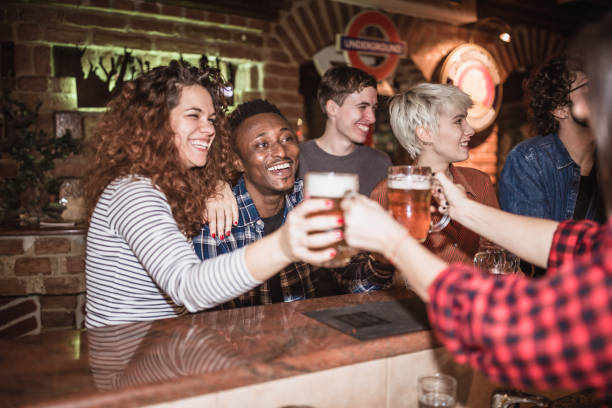 istock Group of friends having fun in the pub, drinking beer 1434380335