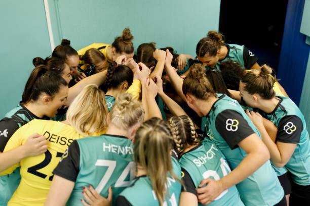 istock Female handball team huddled in locker room before game 1434380463