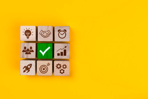 Business process management. Wooden blocks with icon business strategy on yellow background stock photo
