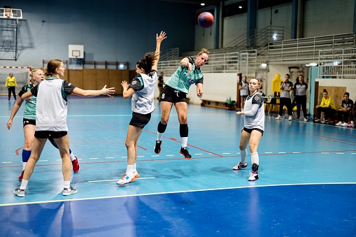 Professional women handball team practicing new strategy during training