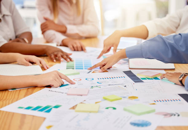 istock Teamwork, collaboration and financial analysis by business people reading document and data reports in corporate office. Team discussing and planning company development and growth strategy together 1434384583