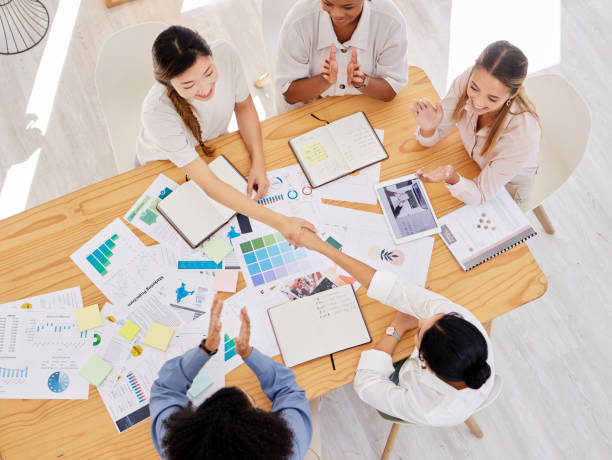 istock Handshake, collaboration and partnership agreement from sales business team working on innovation ideas for target goal. Hand shake or employee thank you for promotion at meeting with data above view 1434385357