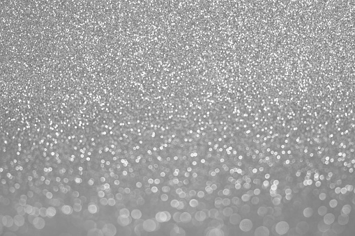 Abstract Glitter Background. Silver Texture Sparkling Shiny Paper for Christmas Holiday. Seasonal Wallpaper Decoration. Greeting and Wedding Invitation Card Design. Sparkle Lights and Bokeh Backdrop. Festive and holiday golden background for text. Defocused abstract backdrop with sparkling glitter and bokeh. Glitzy, glossy effect. Festive background. Mockup