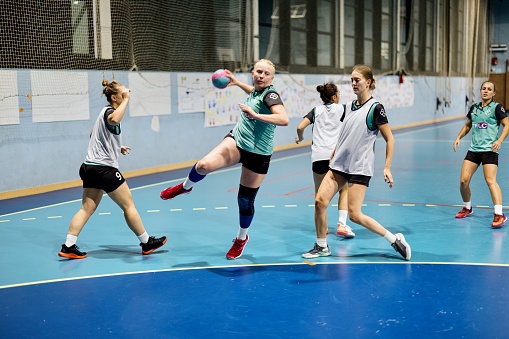 Professional women handball team practicing new strategy during training