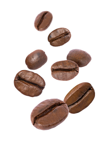 Coffee beans levitate isolated on white background.