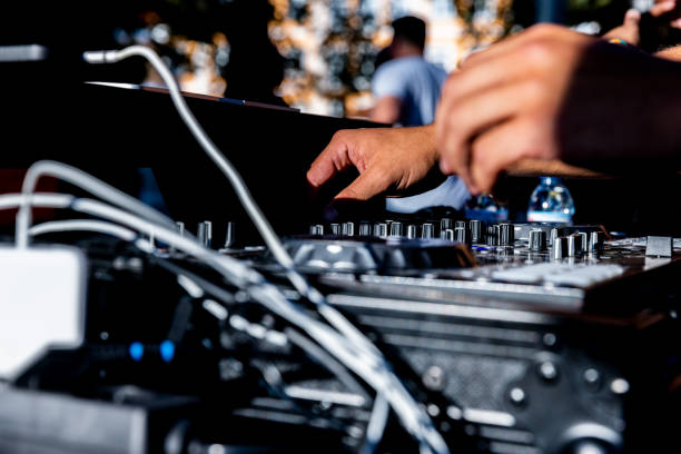 istock DJ hands moving the table with end of day light. 1434389033
