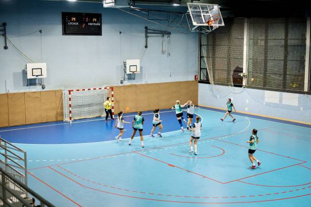 Group of women handball players in action. Female handball players are playing a match at training handball stock pictures, royalty-free photos & images