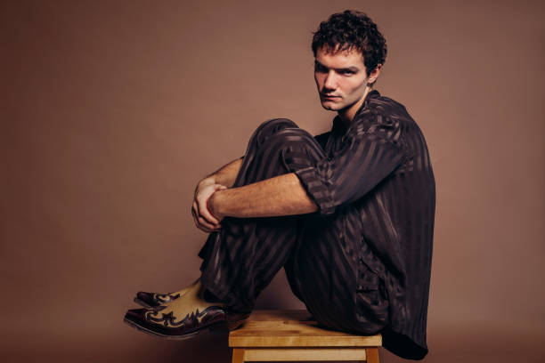 istock Young handsome man sitting on chair at studio 1434391278