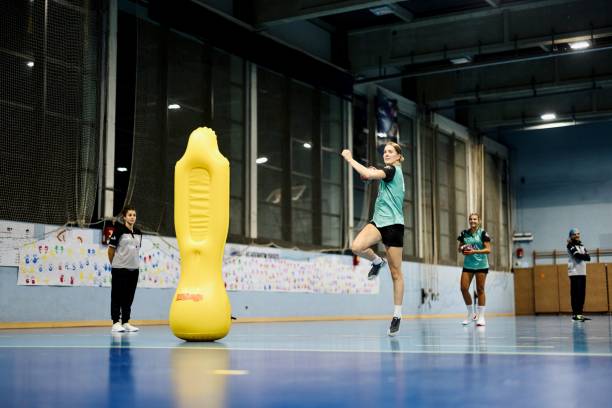 istock Female Handball players practicing jump shot technique 1434391437