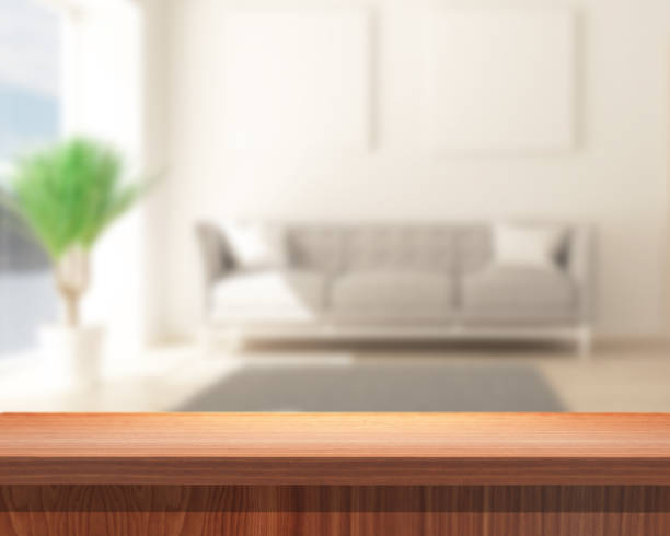 istock 3D wooden table looking out to a defocussed modern lounge 1434393976