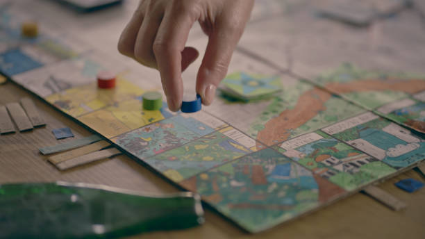 istock Human hand moving the pieces on a game board 1434394126