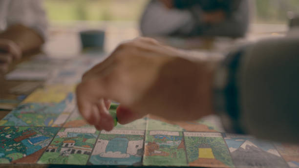 istock Human hand moving the pieces on a game board 1434394166
