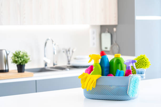 istock Cleaning supplies in a basket on kitchen counter. Copy space 1434398204