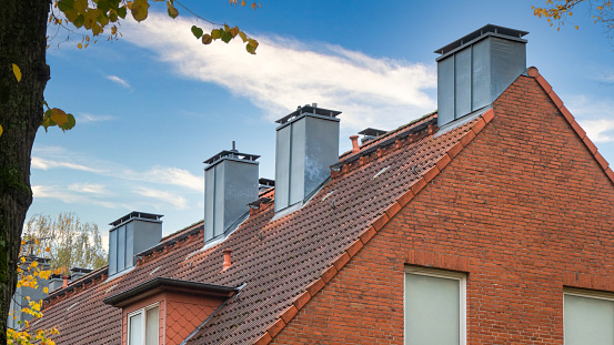 Three Dormers and Two Chimneys on Residential Roof