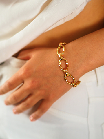 Gold bracelet on a woman wrist