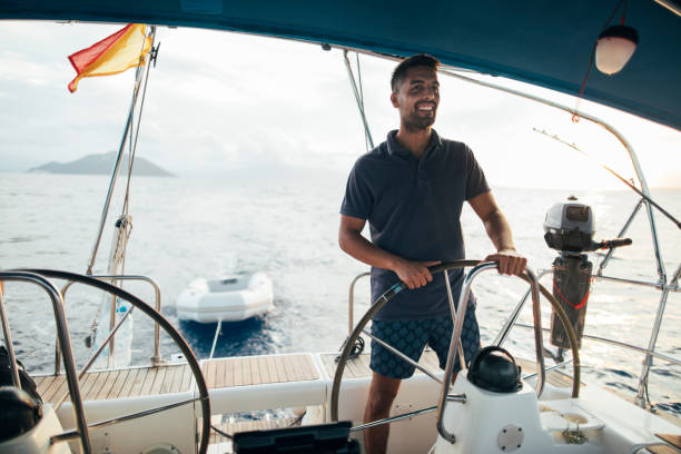 istock Smiling skipper sailing on yacht 1434400719