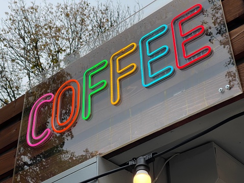 Low angle close up of coffee shop neon sign