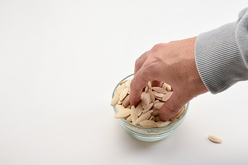 close up of almond nuts on man's hand .