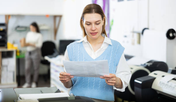 istock Printing office wokrer looking at paper 1434404717