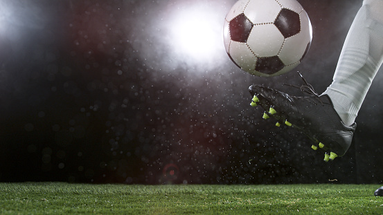 Close-up of Football Player Kicking Soccer Ball