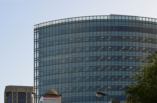 Port of Spain, Trinidad island, Trinidad and Tobago: Nicholas Tower, elliptical blue glass office tower, home to  Trinidad and Tobago Stock Exchange, and Caribbean Airlines - Bynoe Rowe Wiltshire Partnership architects - Independence Square. To the left Eric Williams Plaza.