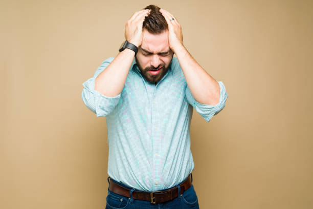 istock Sad young man with a bad migraine 1434409679