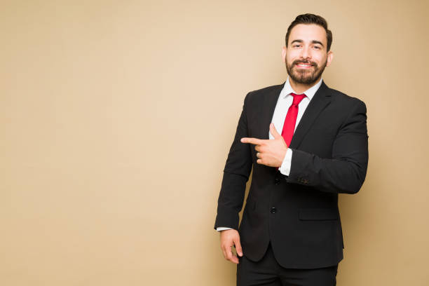 istock Cheerful investor smiling and pointing to copyspace 1434410553