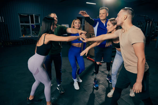 istock Success, motivation, support. Emotional young athletes in sports uniform shaking hands before group training at sport gym, indoors. 1434414736
