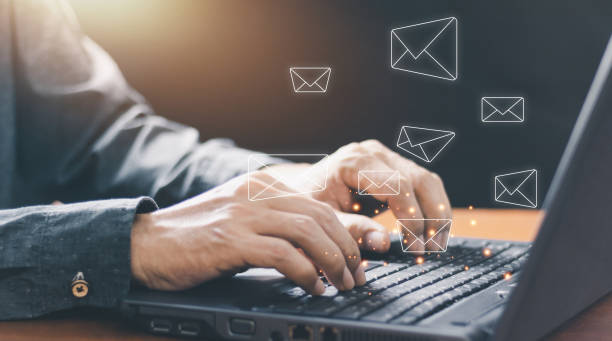 istock Businessman hands using Laptop typing on keyboard and surfing the internet on office table with email icon, email marketing concept, send e-mail or newsletter, online working internet network. 1434416156