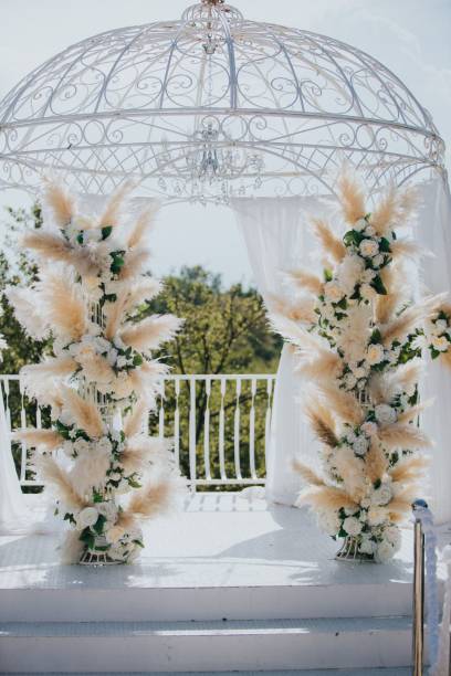 istock White wedding gazebo decorated with cream pampas grass and roses 1434416732
