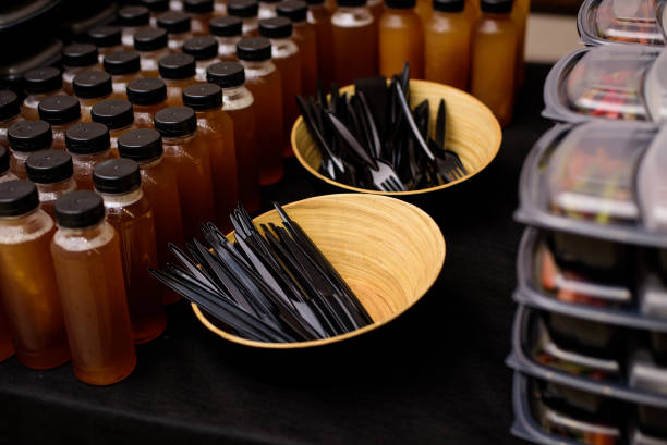 istock Black plastic knives and forks in plates. Catering 1434420747
