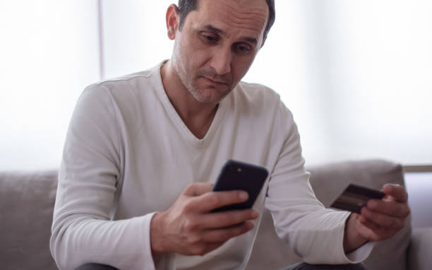 istock Middle-aged man online shopping on his phone. 1434420785