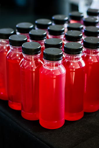 Catering drinks bottles with juice on the black background.