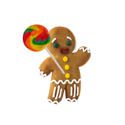 Gingerbread man with a lollipop on a white isolated background. New Year and Christmas concept. Holiday baking.