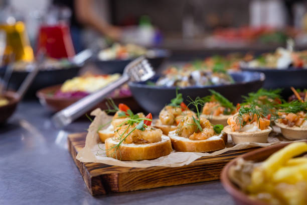 Banquet table served for holiday with canape and different snacks. European food. Catering. Banquet table served for holiday with canape and different snack. European food. Catering. restaurant food canapes appetizers stock pictures, royalty-free photos & images