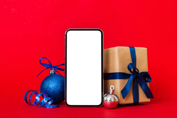 istock Digital phone mock up with rustic Christmas decorations for app presentation with empty space for you design. Christmas online shopping concept. Tablet with copy space on colored background 1434427329