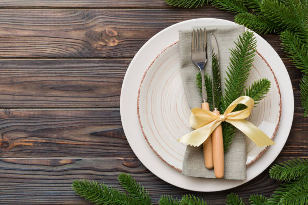 istock Christmas table place setting with christmas decor and plates, kine, fork and spoon. Christmas holiday background. Top view with copy space 1434427375