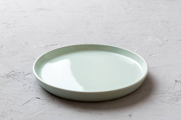 istock Perspective view of empty blue plate on cement background. Empty space for your design 1434428292