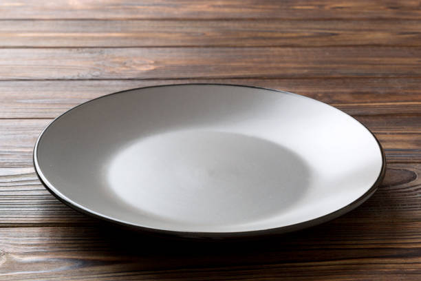 istock Perspective view of empty grey plate on cement background. Empty space for your design 1434428300