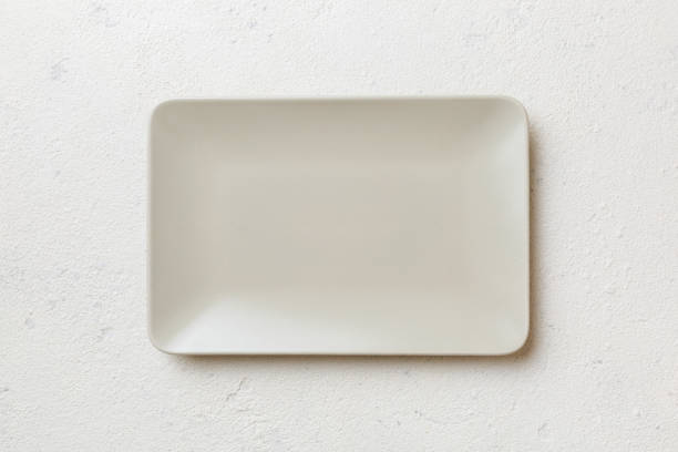 istock Top view of empty square plate on cement background. Empty space for your design 1434428346